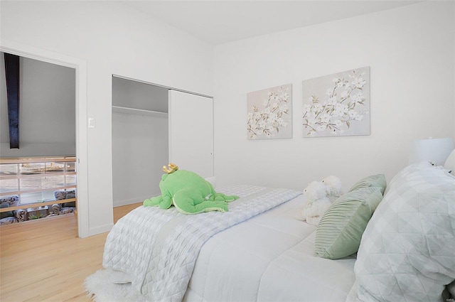 bedroom with hardwood / wood-style floors and a closet