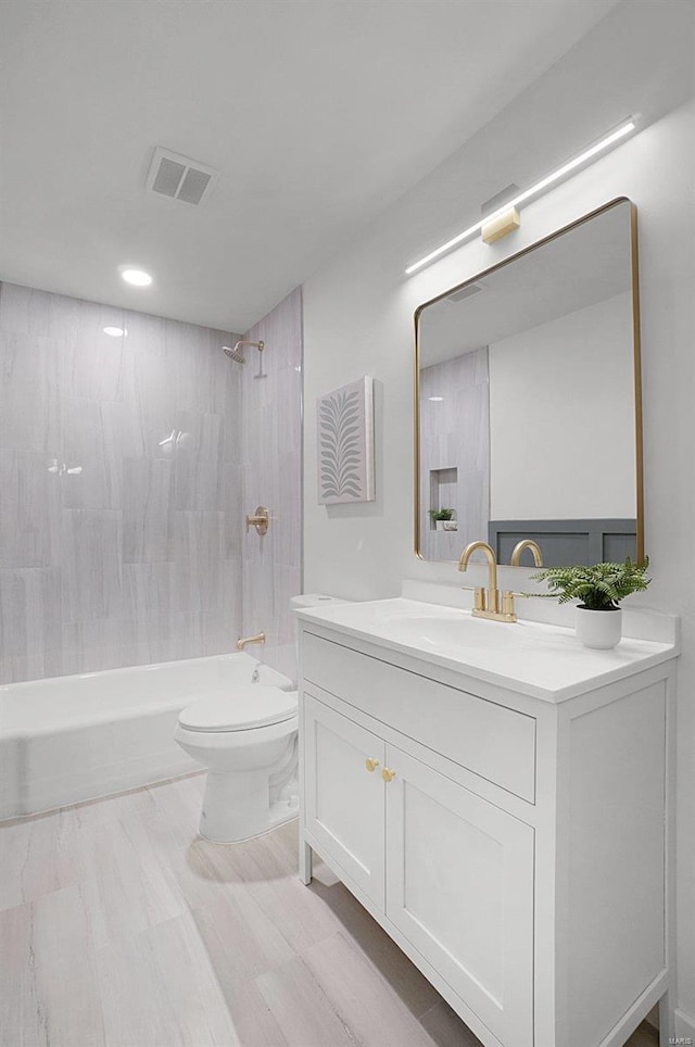 full bathroom with shower / tub combination, vanity, and toilet