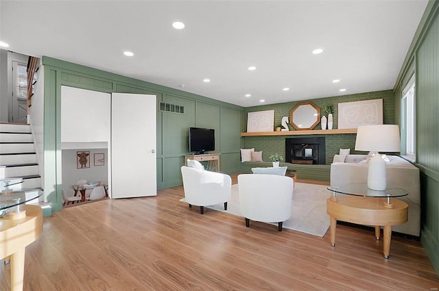 living room featuring a fireplace and light hardwood / wood-style floors