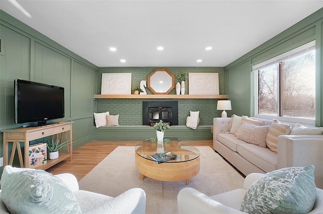 living room featuring light wood-type flooring and a wood stove