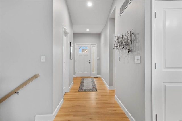 doorway to outside with light wood-style floors, recessed lighting, baseboards, and visible vents