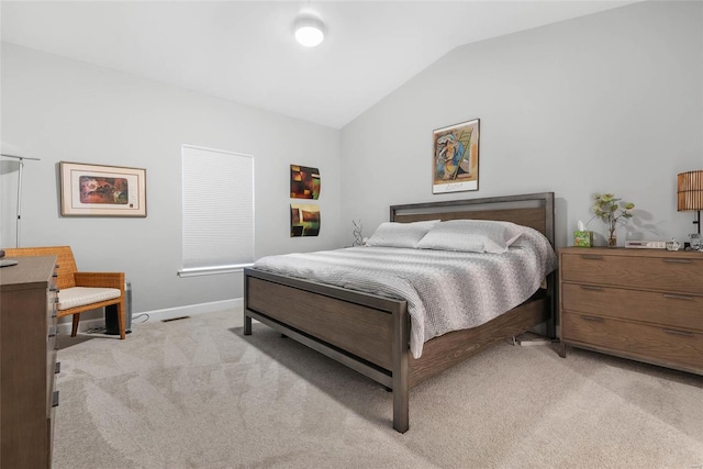 bedroom with visible vents, light colored carpet, baseboards, and lofted ceiling