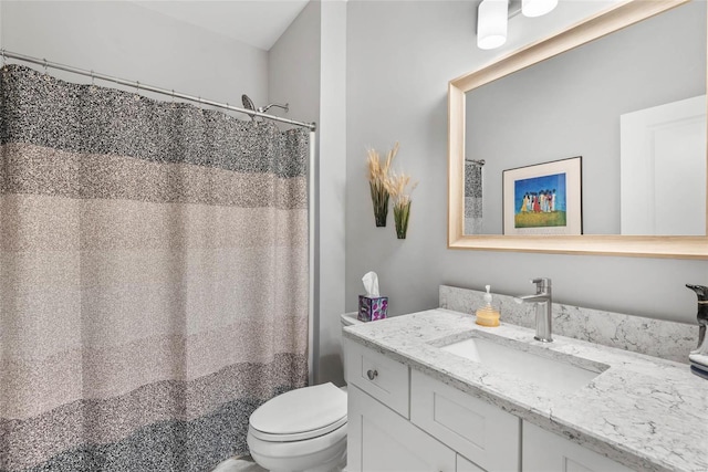 bathroom featuring toilet and vanity