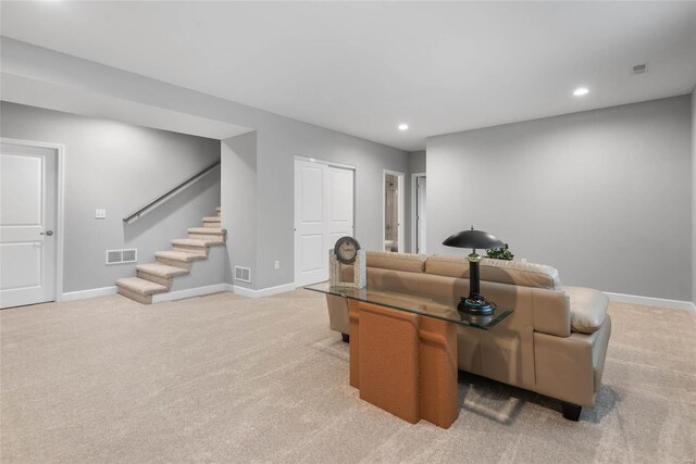 living room featuring visible vents, stairway, and baseboards