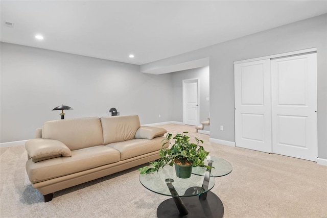 living area with recessed lighting, baseboards, light carpet, and visible vents