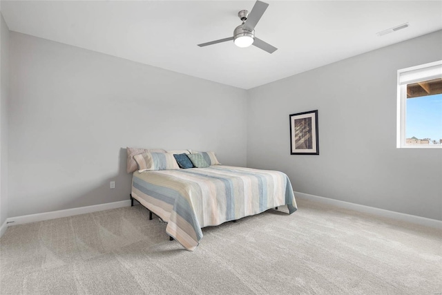 carpeted bedroom with visible vents, ceiling fan, and baseboards