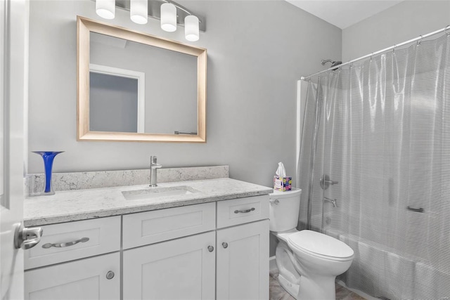 bathroom with toilet, curtained shower, and vanity