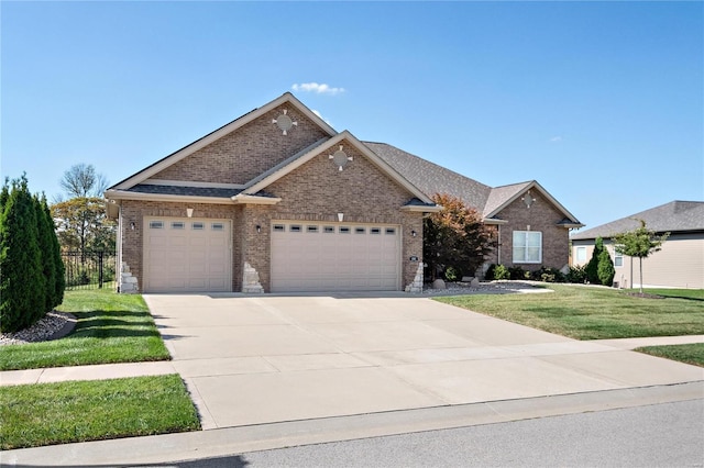 view of front of property with a front lawn and a garage