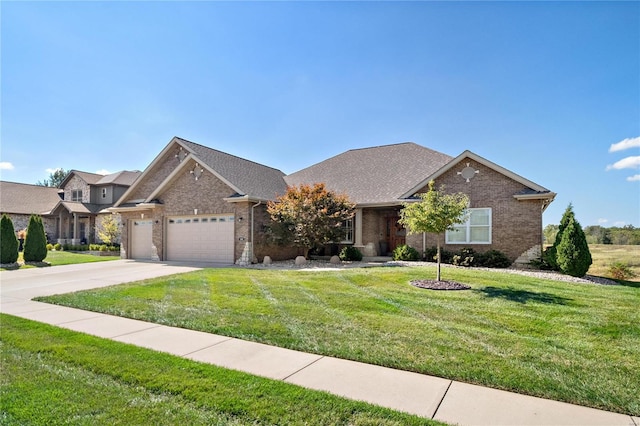 view of front of property featuring a garage and a front lawn