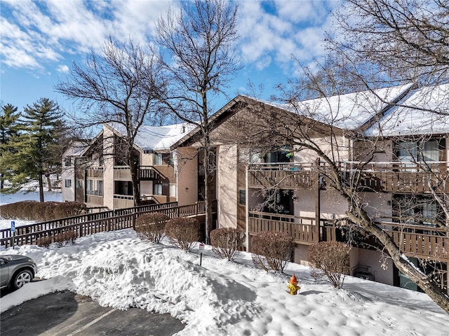 view of snow covered exterior with a balcony