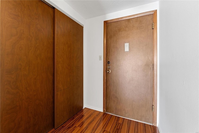 interior space with dark wood-type flooring and a textured ceiling