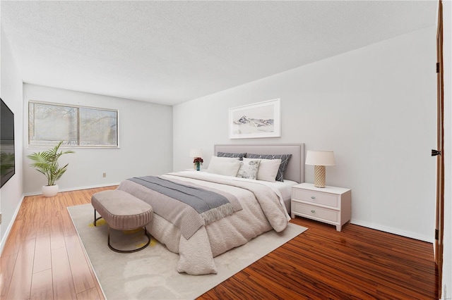 bedroom featuring hardwood / wood-style floors and a textured ceiling