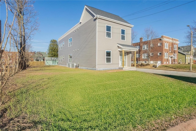 view of side of home featuring a yard