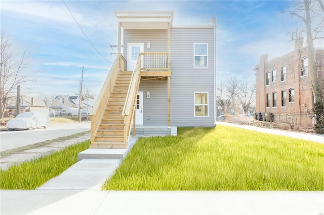 rear view of house featuring a lawn