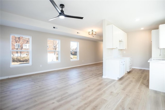 unfurnished living room featuring light hardwood / wood-style flooring and ceiling fan