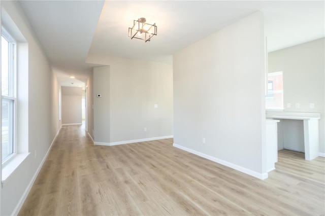 unfurnished room with light wood-type flooring