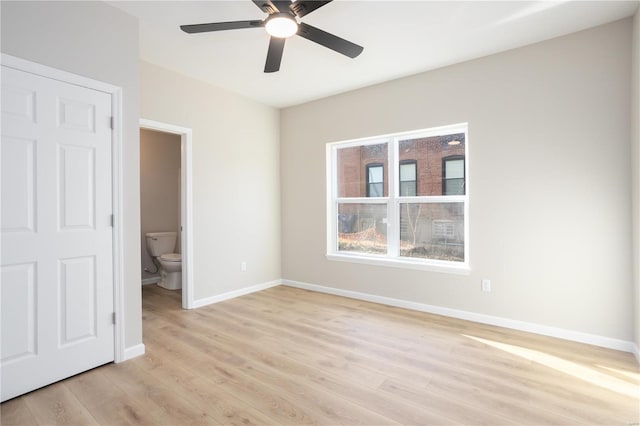 unfurnished bedroom with ensuite bathroom, ceiling fan, and light hardwood / wood-style floors