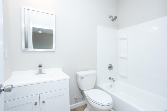 full bathroom featuring washtub / shower combination, vanity, and toilet