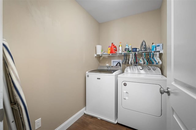 laundry area with dark wood-type flooring and washer and clothes dryer