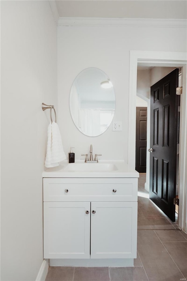 bathroom with tile patterned floors, vanity, and ornamental molding