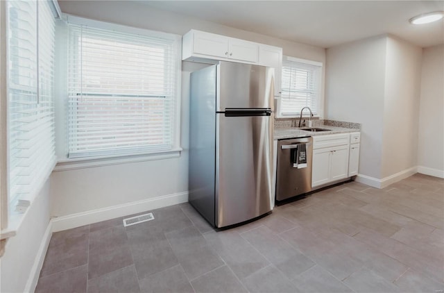 kitchen featuring white cabinetry, sink, and appliances with stainless steel finishes