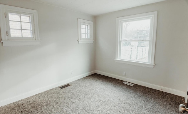 unfurnished room featuring carpet flooring and a healthy amount of sunlight