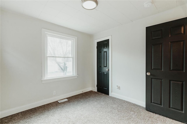 unfurnished bedroom featuring light carpet