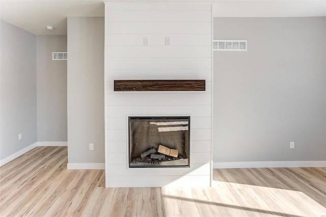 details with a fireplace and hardwood / wood-style flooring