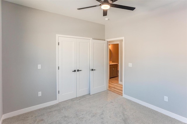 unfurnished bedroom with light carpet, a closet, and ceiling fan