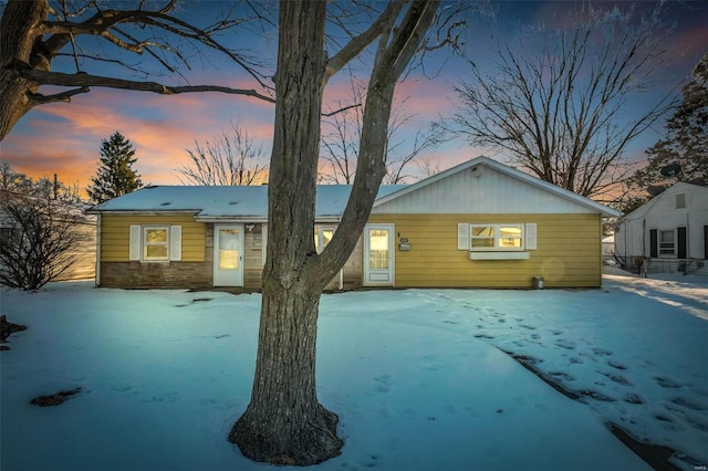 view of snow covered rear of property