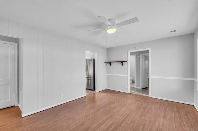 interior space with ceiling fan and light hardwood / wood-style flooring