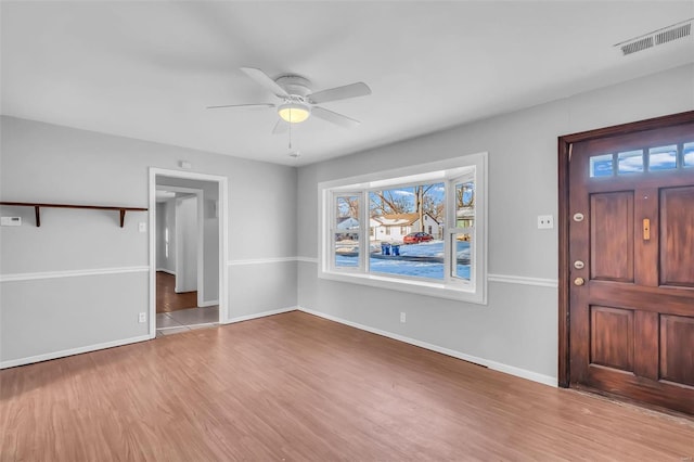 foyer with ceiling fan and light wood-type flooring