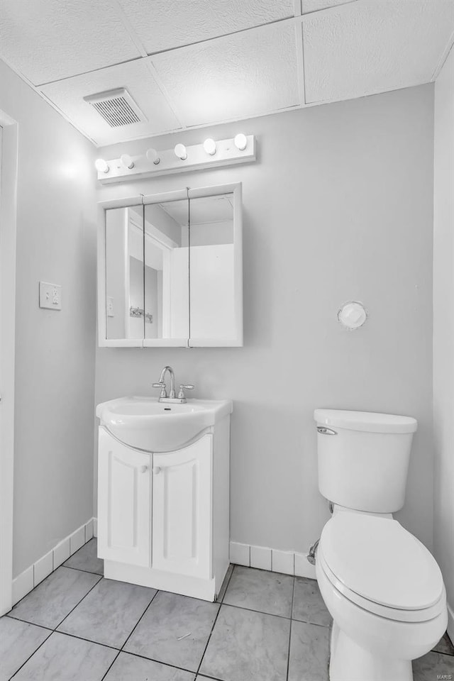 bathroom featuring toilet, vanity, and tile patterned floors