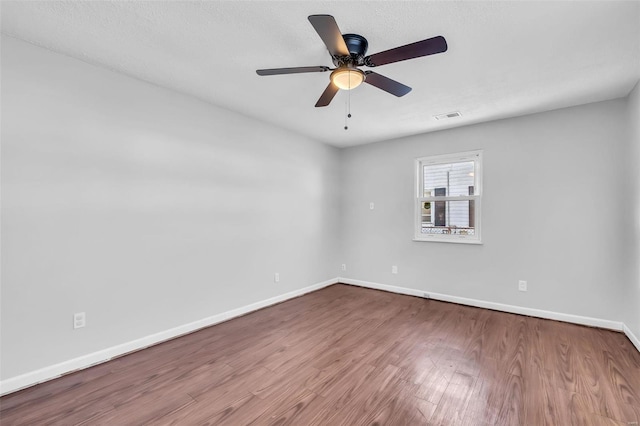 spare room with ceiling fan and light wood-type flooring