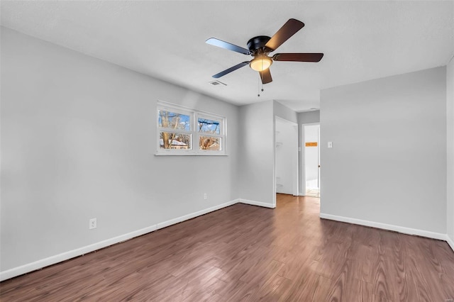 empty room with ceiling fan and hardwood / wood-style floors