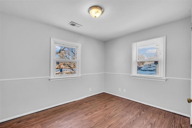 spare room with hardwood / wood-style flooring