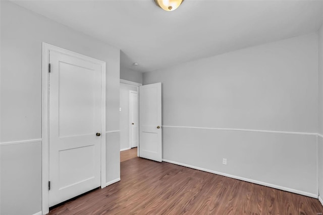 unfurnished bedroom featuring a closet and wood-type flooring