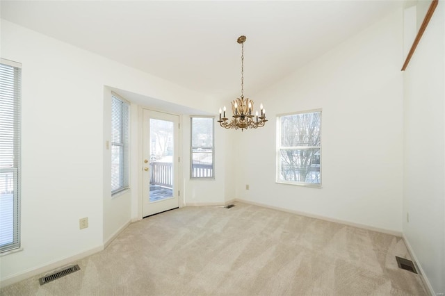 unfurnished dining area with an inviting chandelier, vaulted ceiling, and light carpet