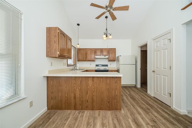 kitchen with white refrigerator, electric range oven, light hardwood / wood-style floors, kitchen peninsula, and pendant lighting