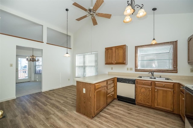 kitchen featuring sink, decorative light fixtures, dishwasher, and kitchen peninsula