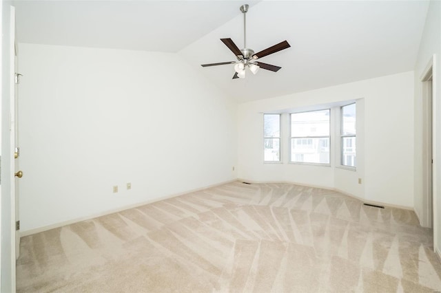 unfurnished room featuring lofted ceiling, light carpet, and ceiling fan