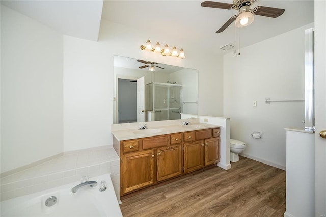 full bathroom featuring toilet, wood-type flooring, vanity, and ceiling fan