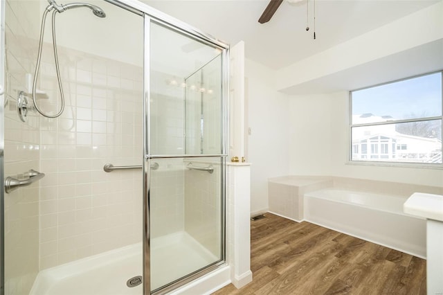 bathroom featuring hardwood / wood-style floors, ceiling fan, and separate shower and tub