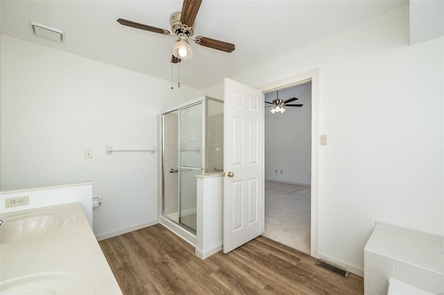 bathroom featuring vanity, a shower with shower door, and hardwood / wood-style floors