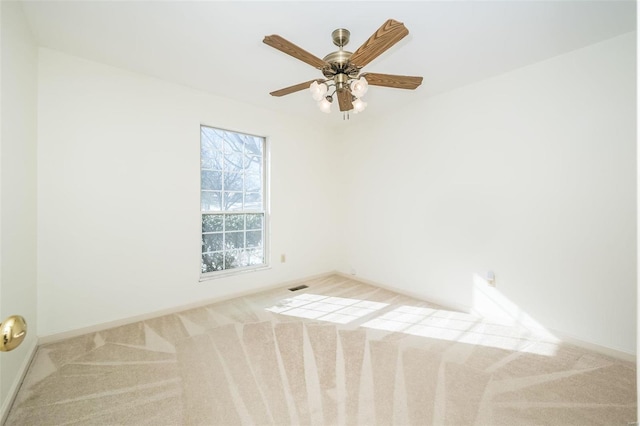 empty room with ceiling fan and light colored carpet