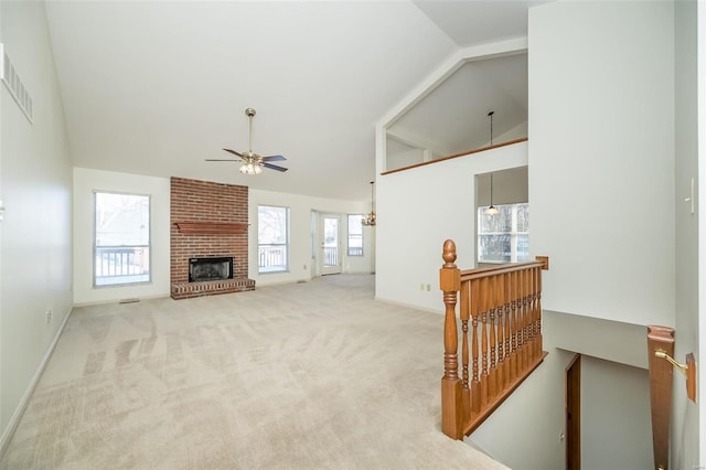 carpeted living room with ceiling fan, lofted ceiling, and a fireplace