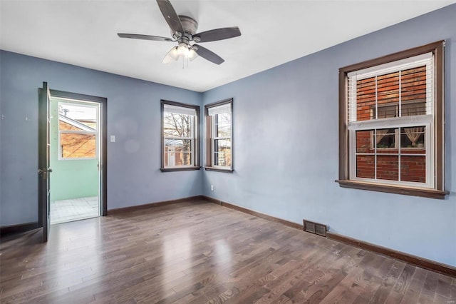 spare room featuring ceiling fan and dark hardwood / wood-style flooring