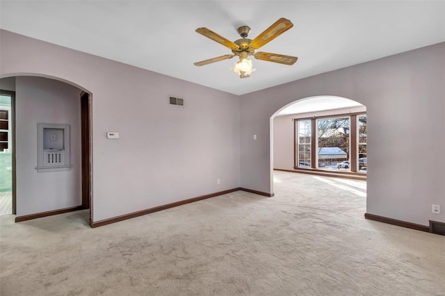 carpeted empty room featuring ceiling fan