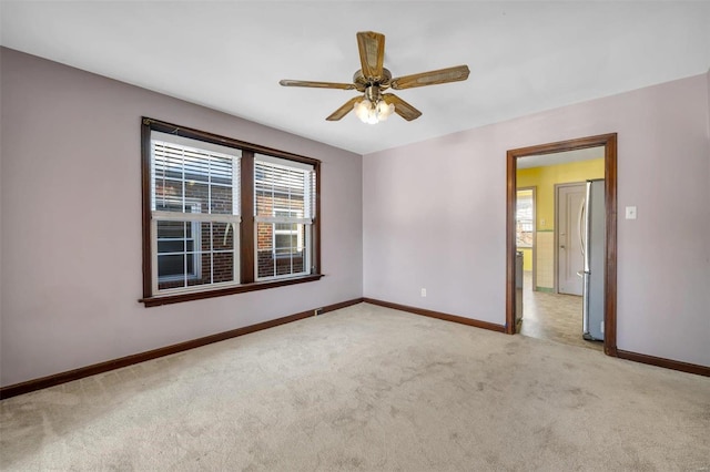 carpeted spare room with ceiling fan