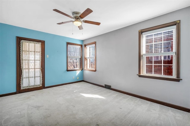 carpeted spare room with ceiling fan